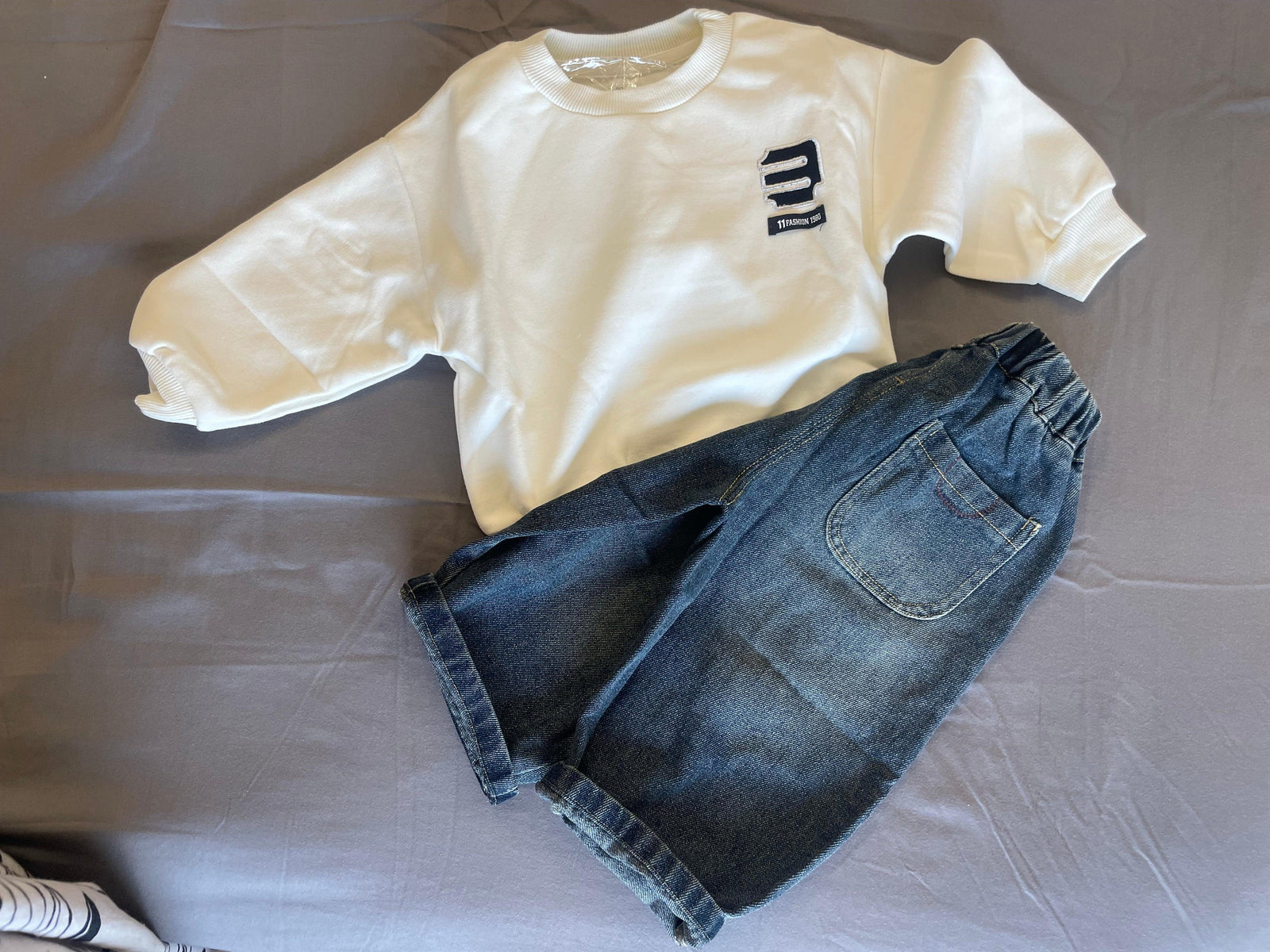 E logo sweatshirt paired with denim pants for kids by Little Aangan