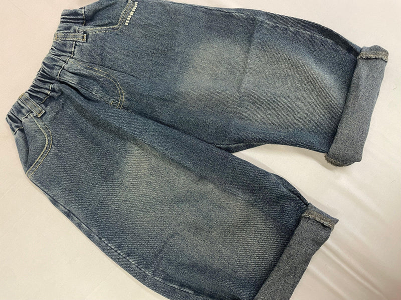 Folded view of blue Korean denim pants showing fabric finish by Little Aangan